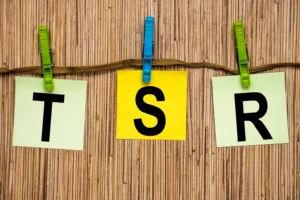 Kolorowe kartki z literami T S R przypięte klamerkami, symbolizujące terapię skoncentrowaną na rozwiązaniach